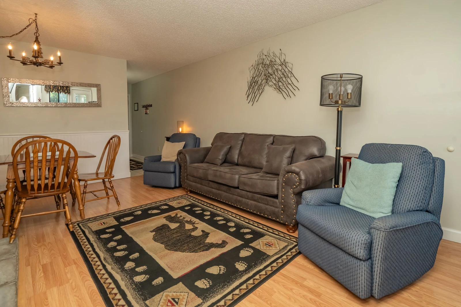 Settle into your cozy living space with comfortable seating and warm lighting, perfect for unwinding after your mountain adventures. The open layout flows seamlessly into the dining area, giving you plenty of room to relax and recharge.