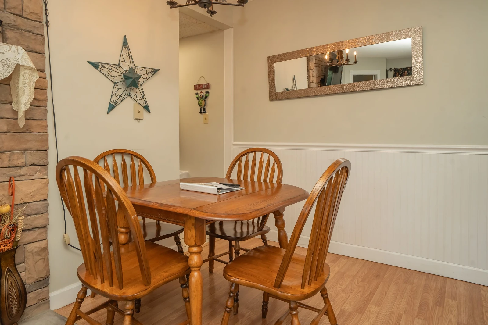 Gather around this inviting dining table for meals and conversation. The warm wood tones and cozy fireplace create a welcoming space where you can enjoy quality time together.