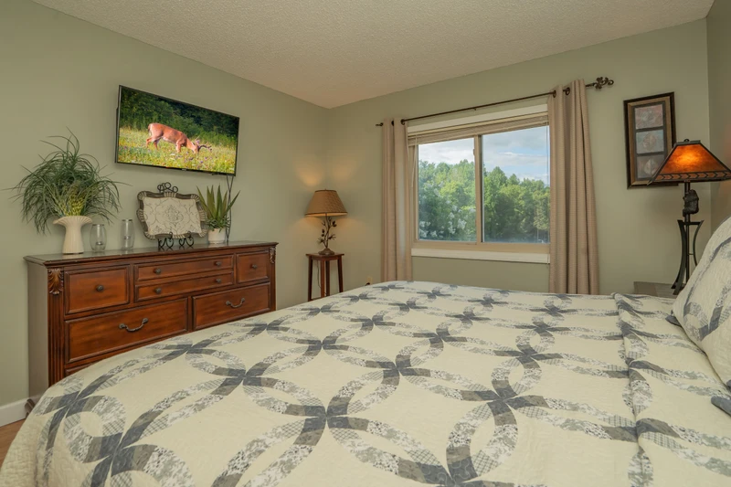 Drift off in comfort with lush greenery framing your window view. Thoughtful touches like soft bedding, warm lighting, and tasteful décor create your perfect retreat.