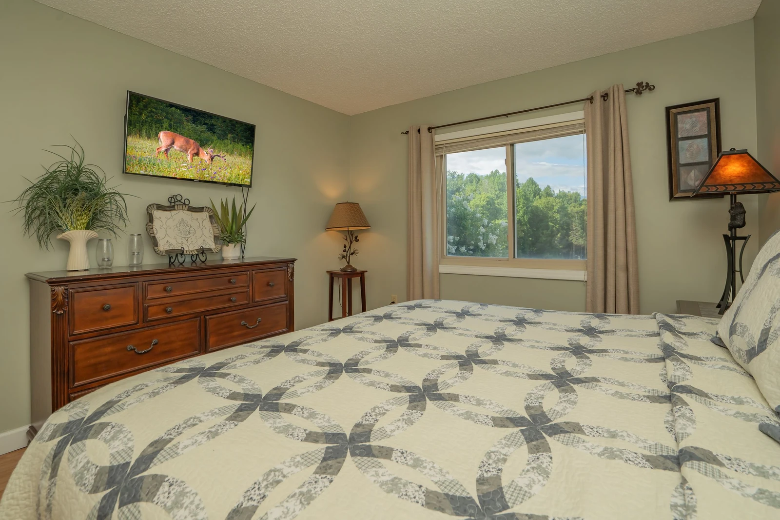 Drift off in comfort with lush greenery framing your window view. Thoughtful touches like soft bedding, warm lighting, and tasteful décor create your perfect retreat.