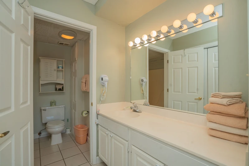 Step into your bright, serene bathroom where soft lighting and fresh towels welcome you. The spacious vanity gives you plenty of room to unwind and prepare for your day in comfort.