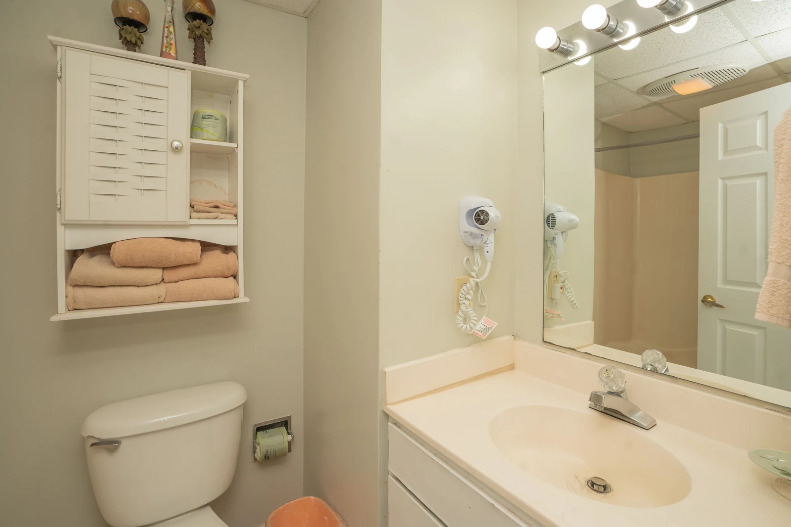 Your private bathroom features fresh towels, a hair dryer, and thoughtful storage for a comfortable stay.