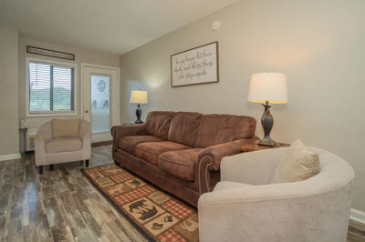 Settle into this inviting living room with comfortable seating and warm lighting, perfect for relaxing after your day's adventures.