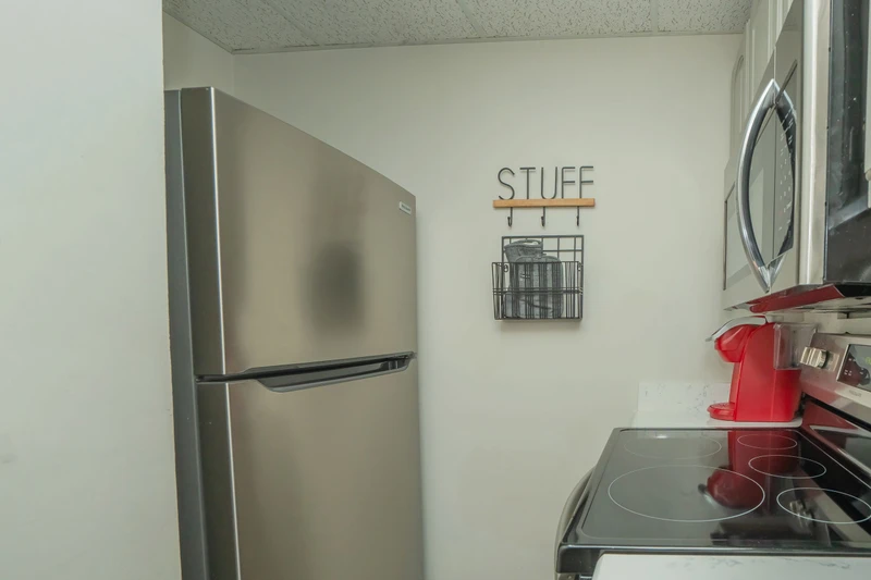Your fully equipped kitchen makes meal prep a breeze, with modern stainless appliances, a smooth cooktop, and all the essentials right at hand.