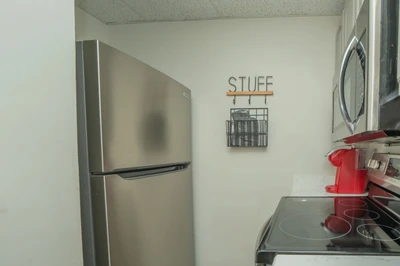 Your fully equipped kitchen makes meal prep a breeze, with modern stainless appliances, a smooth cooktop, and all the essentials right at hand.