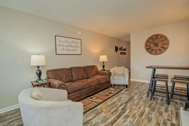 Settle into this inviting living room where warm lighting and comfortable seating create the perfect spot for your evening conversations and relaxation.