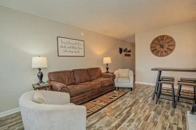 Settle into this inviting living room where warm lighting and comfortable seating create the perfect spot for your evening conversations and relaxation.