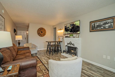 Sink into plush seating by your own fireplace, where rustic charm meets cozy comfort—perfect for winding down after your day's adventures.