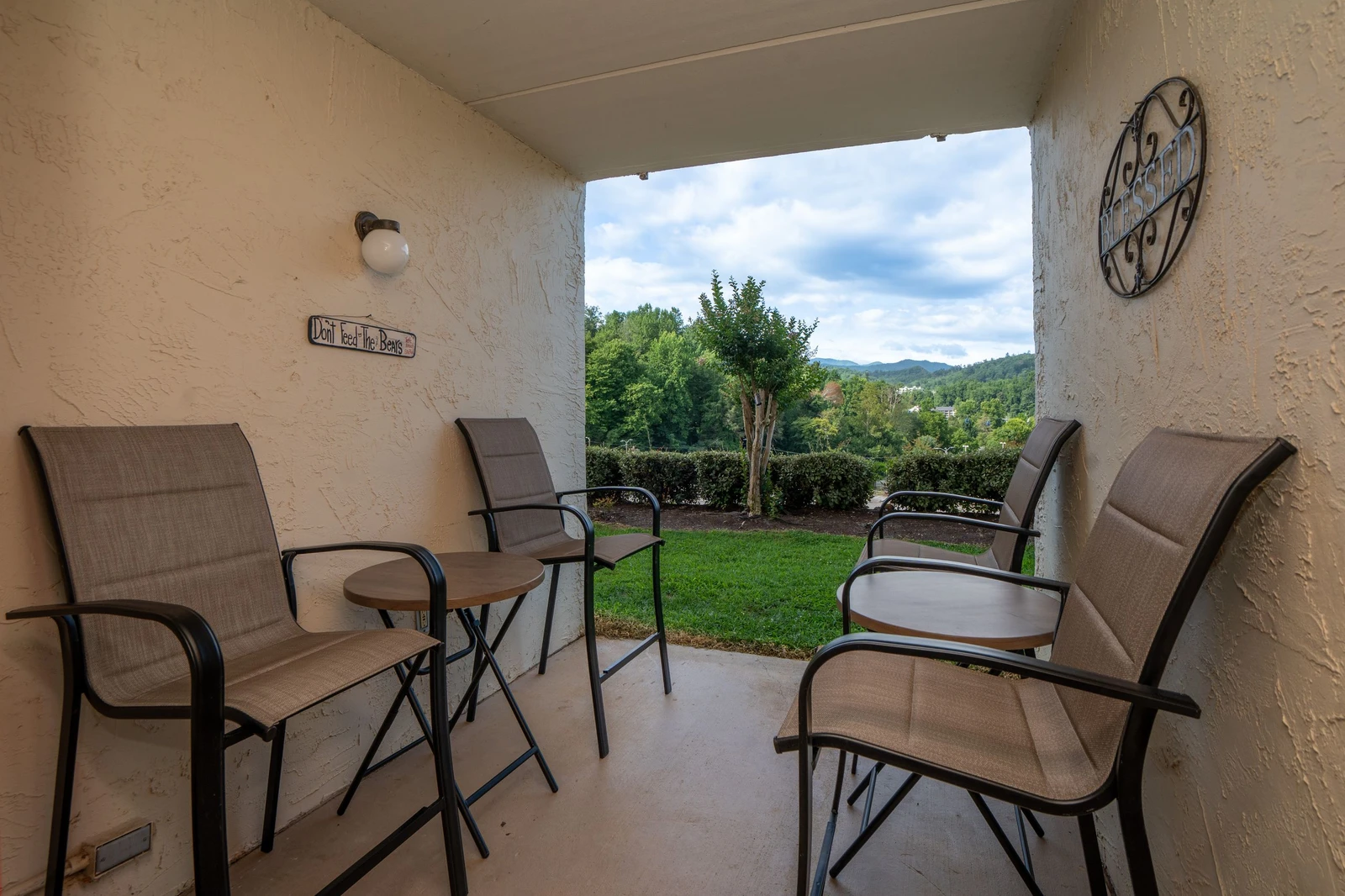 The property sits in a scenic area with lush greenery and distant mountain views visible from the grounds.
