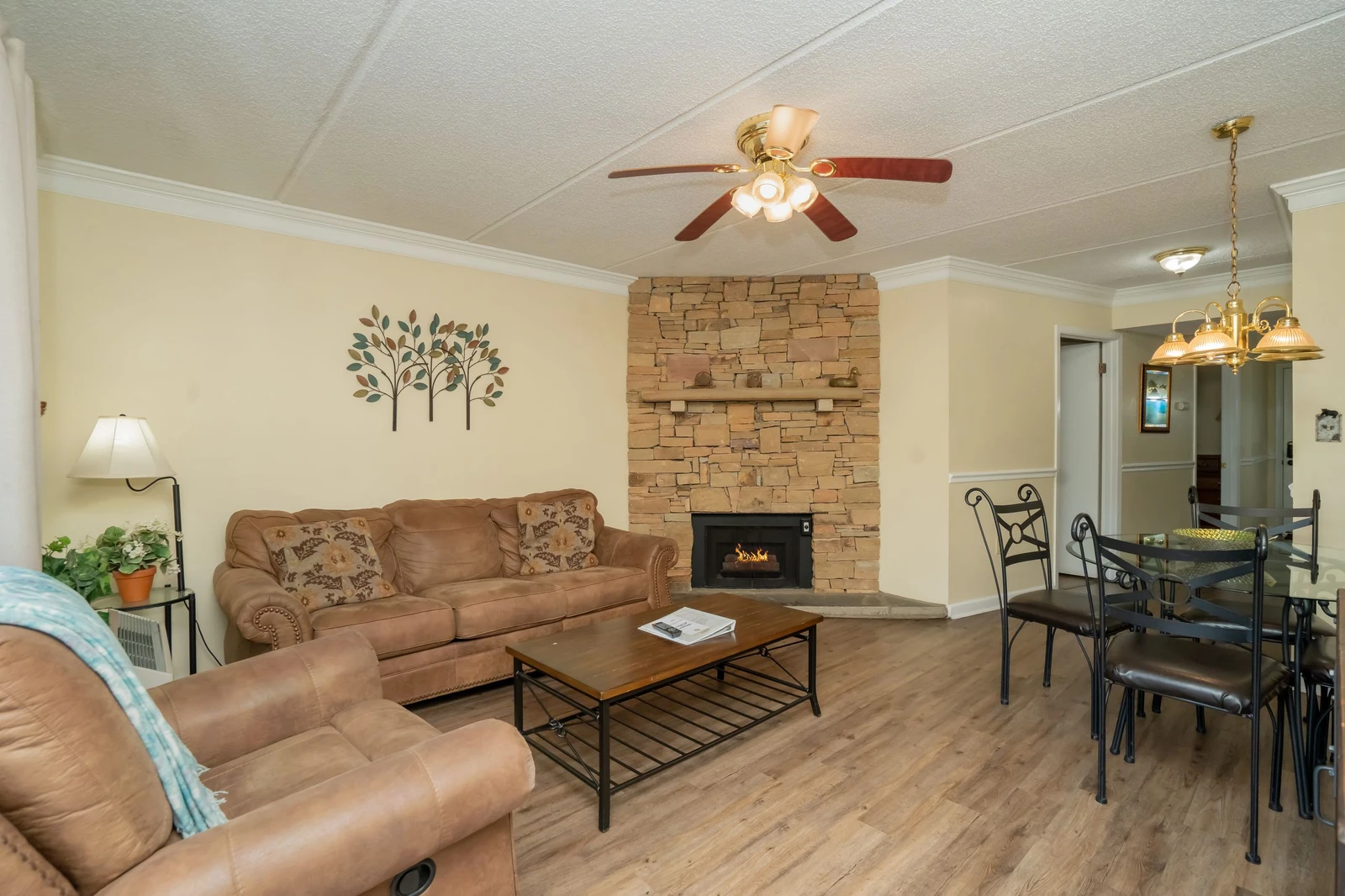 Settle into comfortable seating by the warm glow of your fireplace, where stylish decor and hardwood floors create an inviting space to unwind after your adventures.