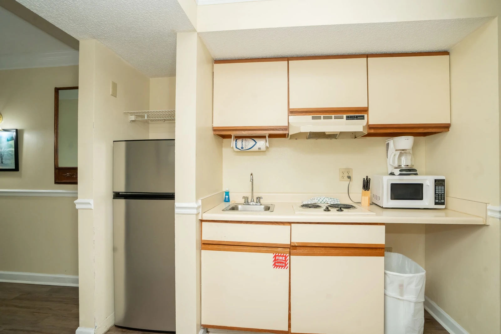 Step into your fully equipped kitchen, ready for preparing meals with a stove, microwave, refrigerator, and coffee maker—everything you need for a comfortable stay.