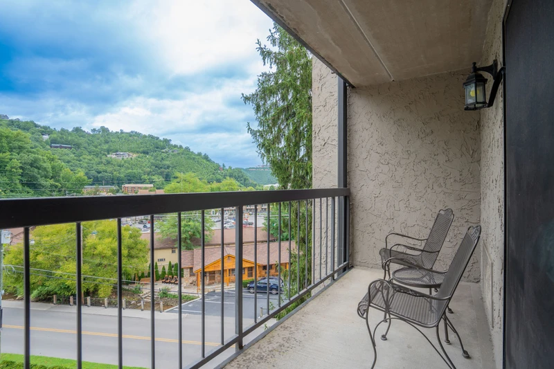 Settle into your private balcony with mountain views rolling into the distance. Two cozy chairs invite quiet mornings with coffee or peaceful evenings under the outdoor light.