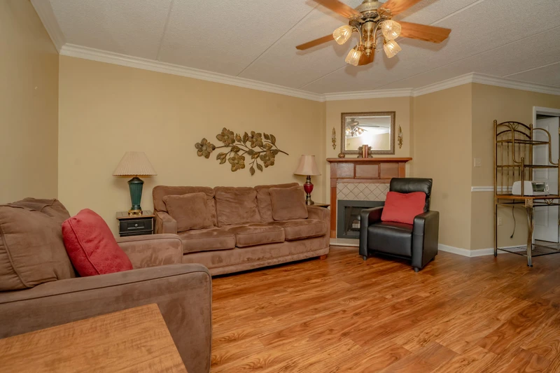 Settle into your spacious living room with plush seating, warm wood floors, and a cozy fireplace—perfect for unwinding after a day of exploring.