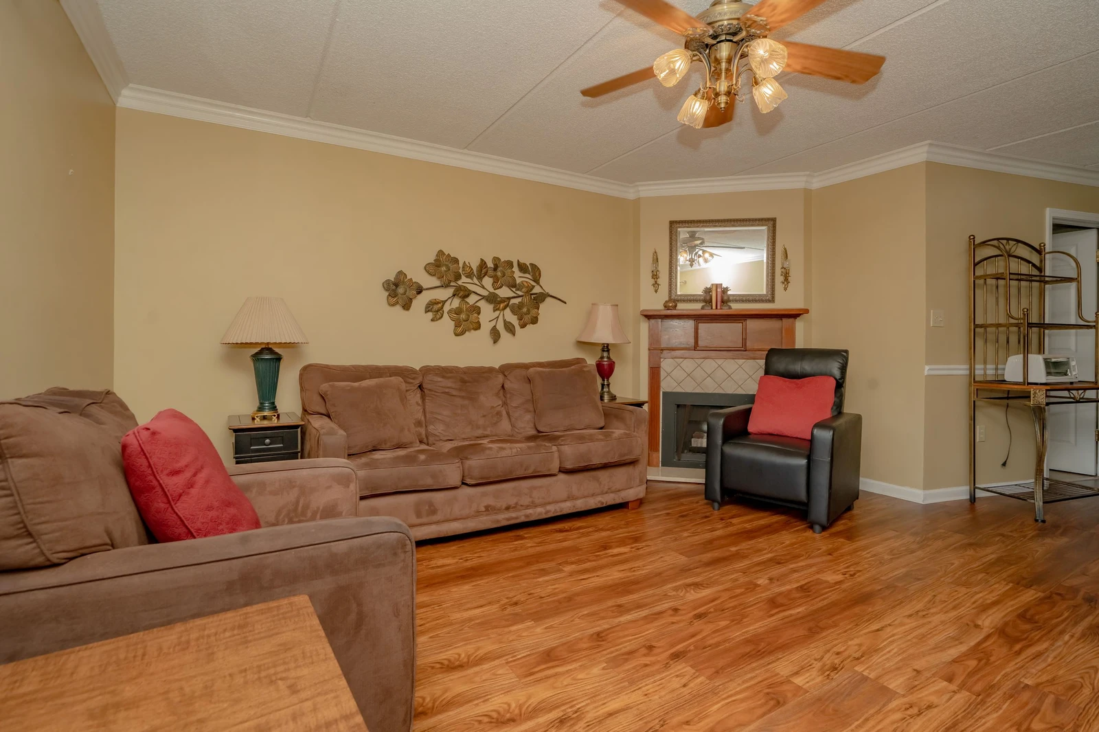 Settle into your spacious living room with plush seating, warm wood floors, and a cozy fireplace—perfect for unwinding after a day of exploring.