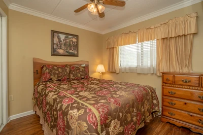 Drift off to sleep under the gentle hum of your ceiling fan, wrapped in soft linens and warm natural light filtering through the curtains—your cozy retreat awaits.