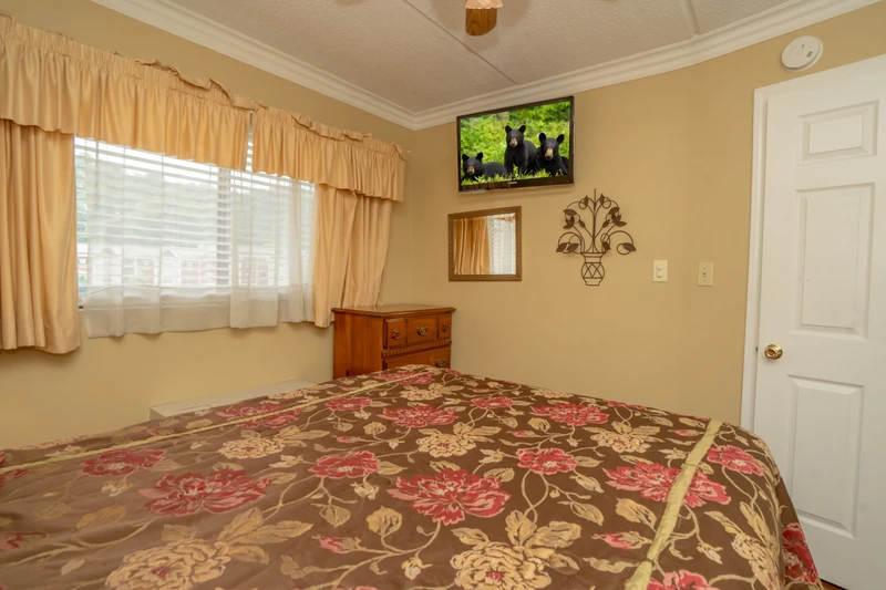 Relax in this cozy bedroom with warm natural light, soft linens, and a peaceful ambiance perfect for restful nights during your getaway.