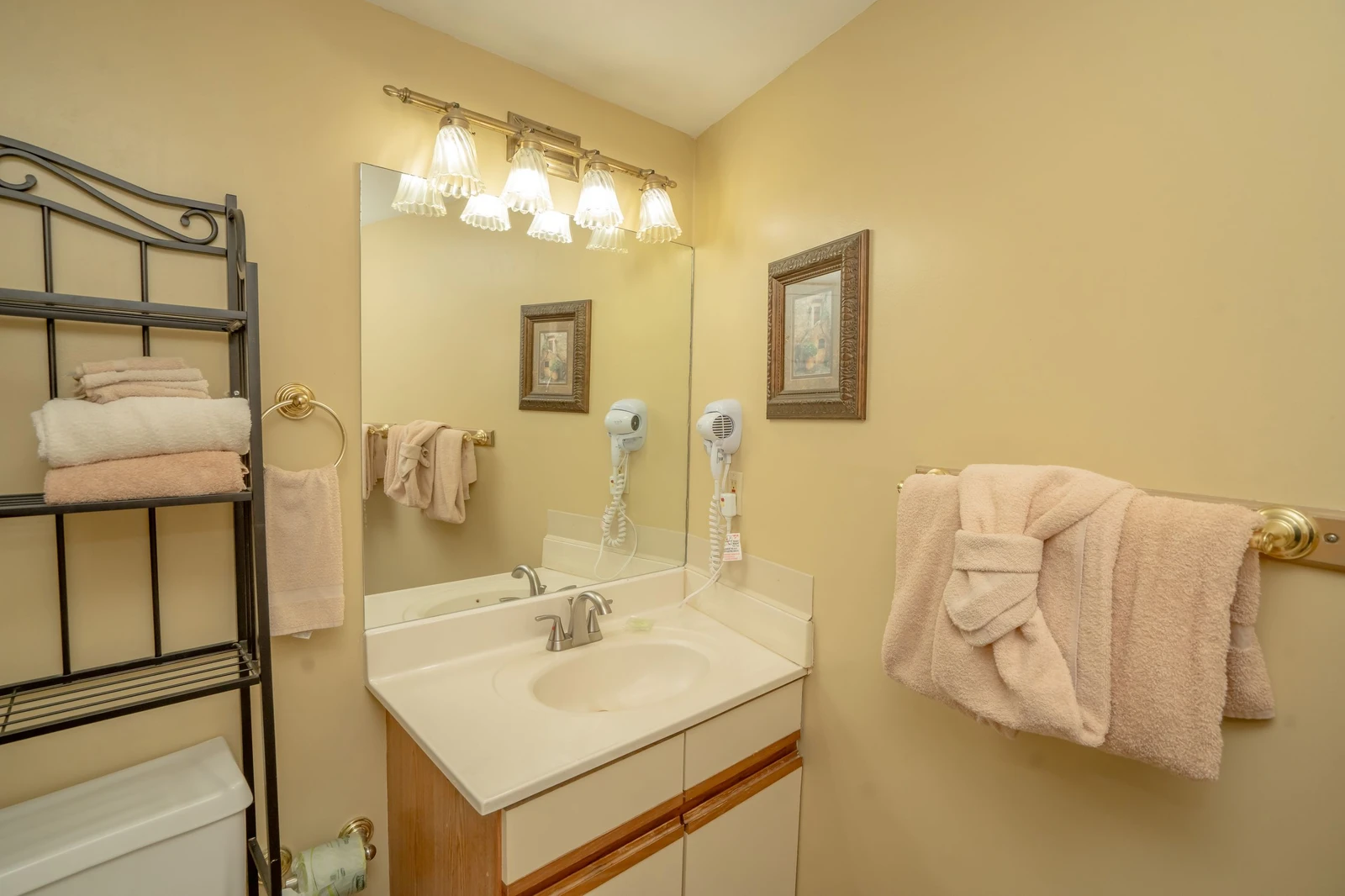 Your private bathroom offers soft lighting, fresh towels, and a welcoming vanity where you can comfortably get ready for the day ahead.