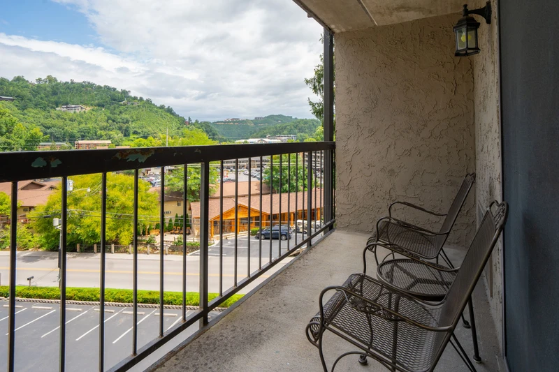 Your private balcony overlooks lush green hills and the surrounding area, offering a peaceful retreat where you can unwind with mountain air and scenic views.