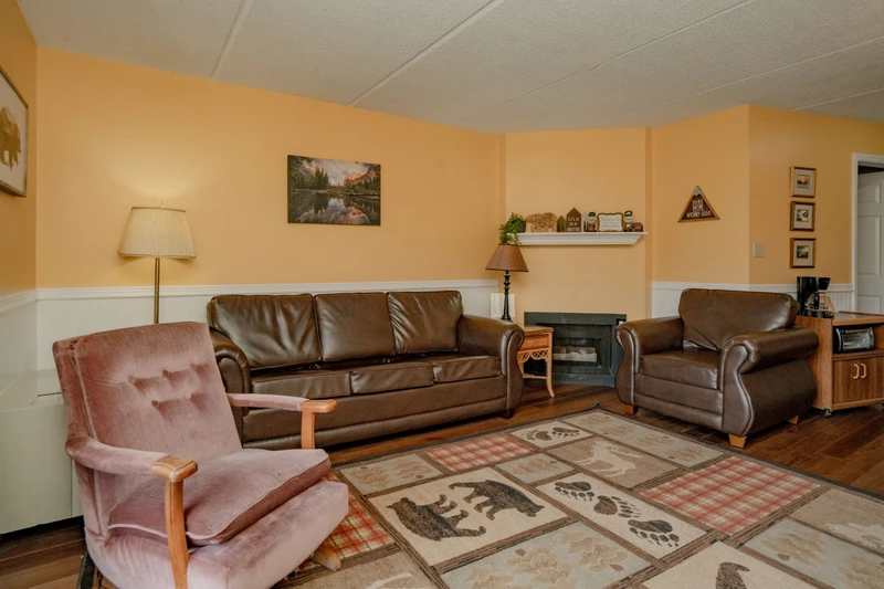 Settle into these comfy leather sofas and cozy armchairs after a day exploring—your peaceful home base awaits with warm lighting and rustic charm.