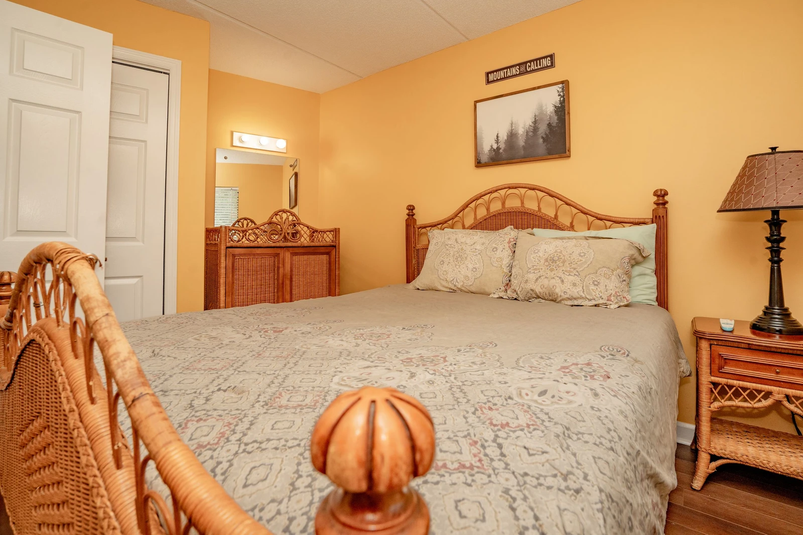 Drift off in this warm, inviting bedroom with its charming wicker furnishings and soft linens. Your cozy retreat awaits after a day of mountain adventures.