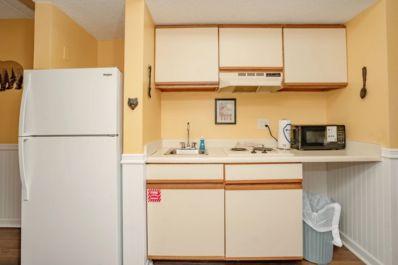 Your cozy kitchenette is fully equipped for easy meal prep, with a fridge, microwave, stove, and plenty of counter space to make yourself at home.