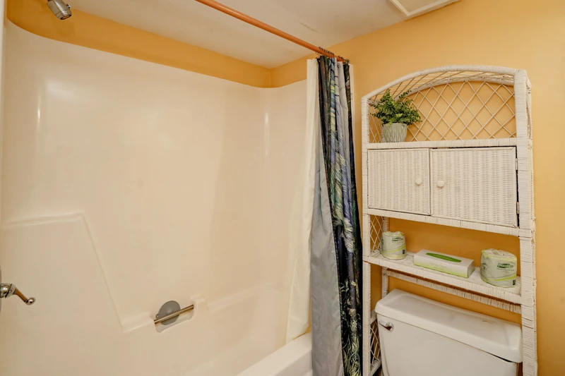 Your bright bathroom comes with a full tub-shower combo and thoughtful wicker storage—everything you need to freshen up and feel at home after a day of exploring.