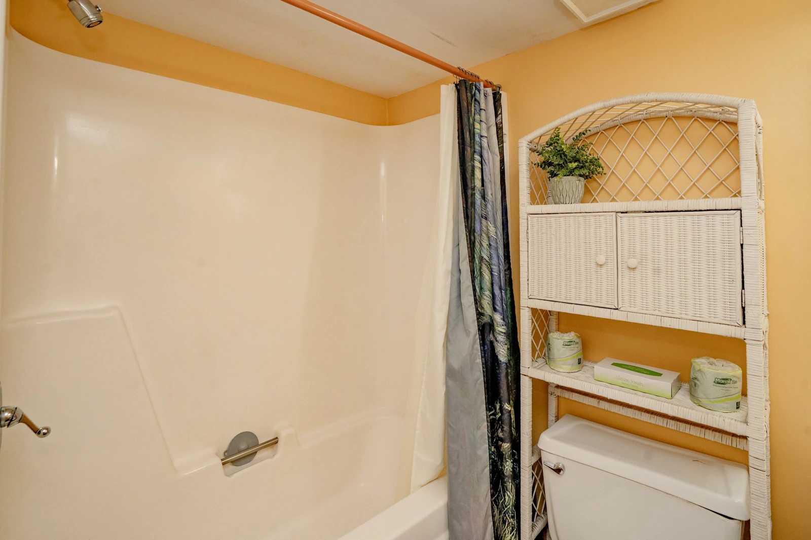 Your bright bathroom comes with a full tub-shower combo and thoughtful wicker storage—everything you need to freshen up and feel at home after a day of exploring.
