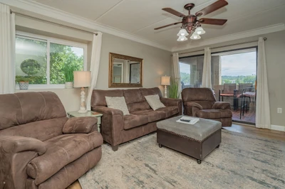 Settle into this inviting living room where plush seating and gentle natural light create your perfect retreat. Step onto the balcony to take in the peaceful mountain views.