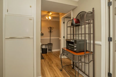 Your fully stocked kitchen opens into a cozy hallway, complete with everything you need for easy meal prep and storage during your stay.