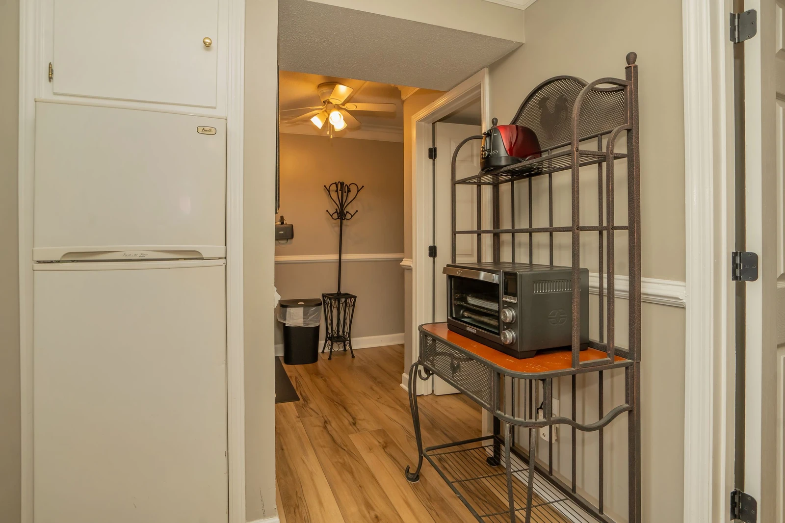Your fully stocked kitchen opens into a cozy hallway, complete with everything you need for easy meal prep and storage during your stay.