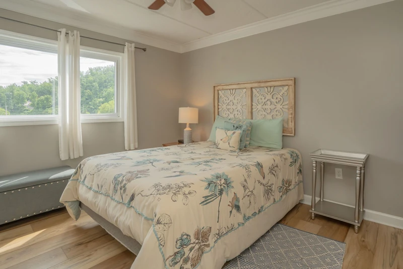Unwind in your serene bedroom, where soft linens and natural light create the perfect retreat. Wake to peaceful garden views and drift off under the gentle hum of your ceiling fan.
