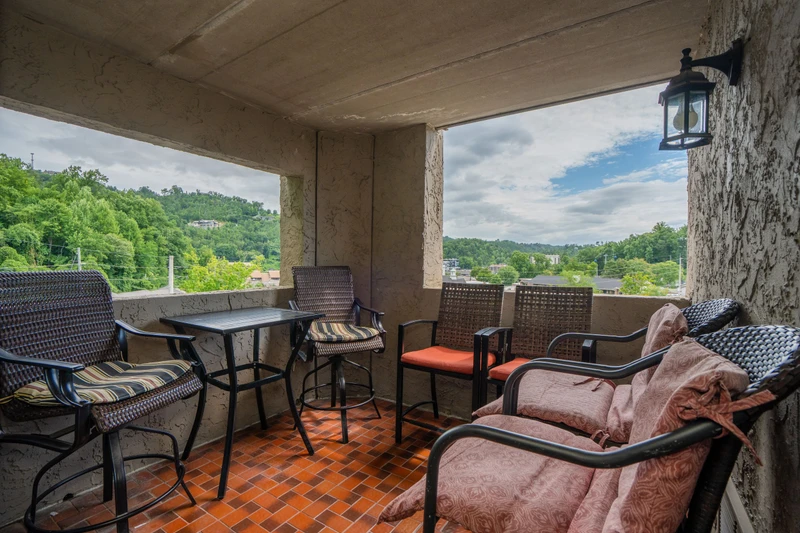 Unwind on your private covered balcony with sweeping views of lush hills and treetops. Comfortable seating invites you to sip morning coffee or enjoy an evening breeze surrounded by natural beauty.