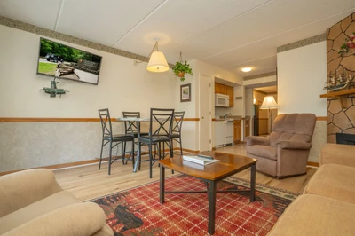 Settle into your inviting living space, where comfortable seating and a warm dining area create the perfect setting for relaxed evenings. The open layout connects seamlessly to your kitchen, making it easy to unwind after a day of exploring.