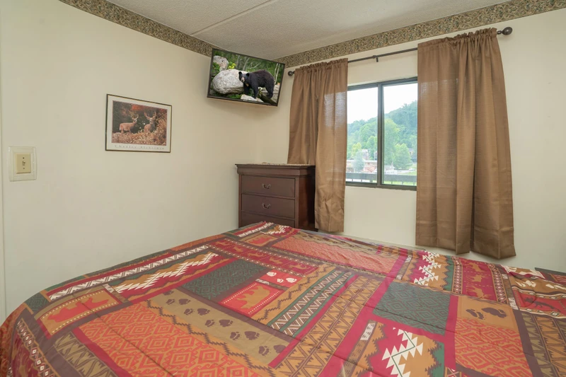 Relax in your comfortable bedroom with views of the surrounding mountains. The rustic décor and natural light create a peaceful retreat after a day of exploring.