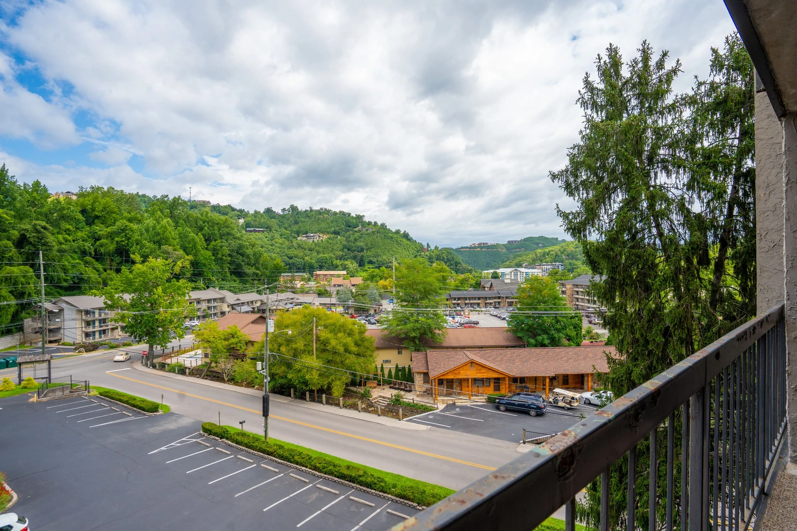 The property offers views of the surrounding area, with green hillsides, neighboring buildings, and a peaceful wooded setting just outside your door.