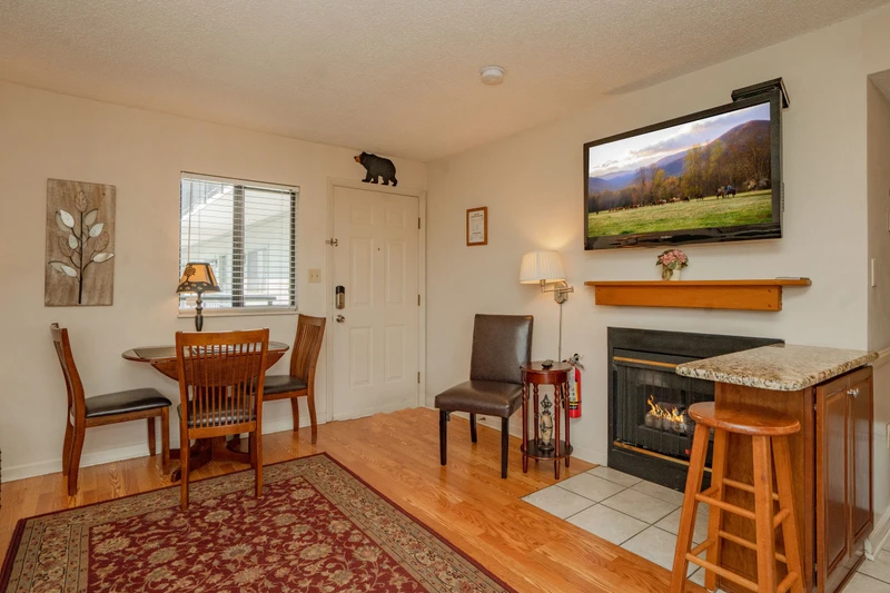 Your cozy retreat features warm wood furnishings, a welcoming fireplace, and a convenient breakfast bar where you can enjoy morning coffee or evening cocktails in comfort.