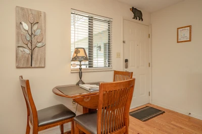 Step inside to find a cozy dining nook bathed in natural light—perfect for your morning coffee or planning the day's adventures. The warm wood tones and charming details make every meal feel special.