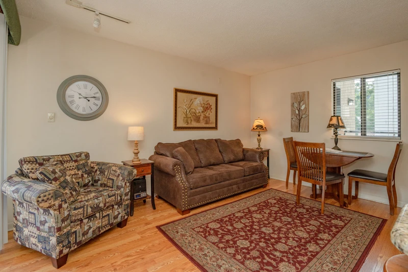 Relax in your cozy living space with comfortable seating, warm lighting, and a welcoming dining nook—perfect for unwinding after exploring nearby attractions.