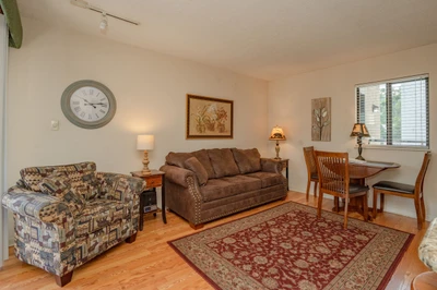 Relax in your cozy living space with comfortable seating, warm lighting, and a welcoming dining nook—perfect for unwinding after exploring nearby attractions.