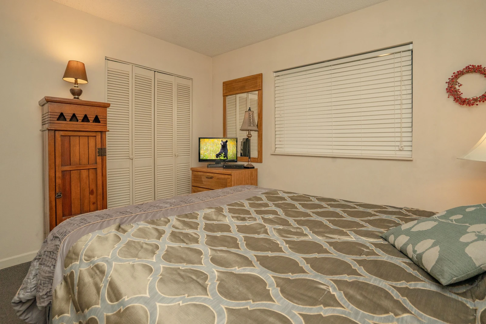 Step into your cozy bedroom retreat, where soft lighting and warm wood accents create a peaceful haven for restful nights.