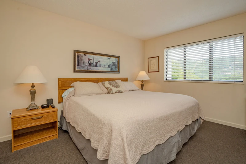 Step into your peaceful retreat, where soft natural light streams through the window beside your plush bed. Unwind on crisp linens after a day of exploration and enjoy the gentle glow of bedside lamps as evening settles in.
