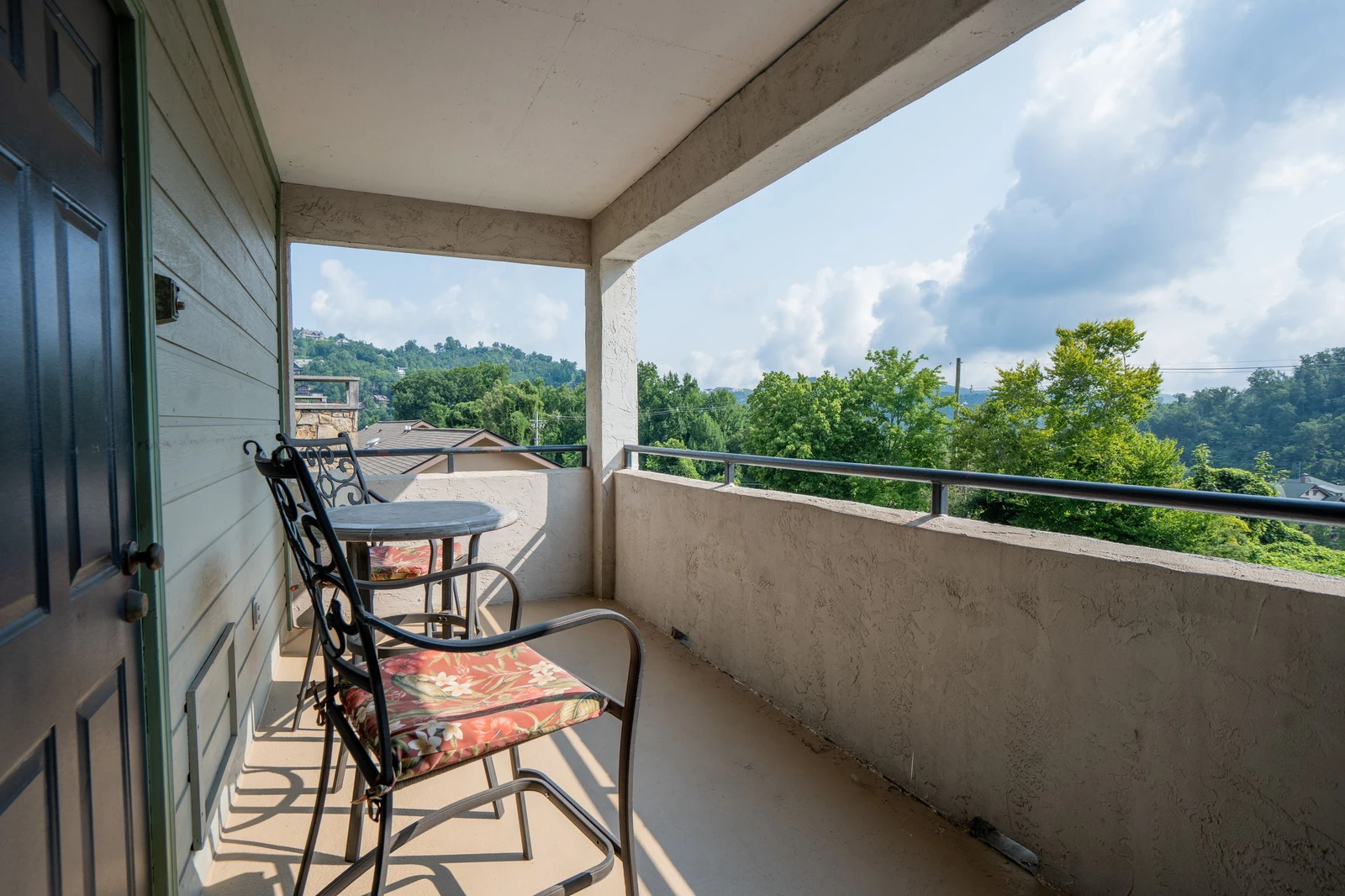 Step onto your private balcony, sink into a cozy chair, and drink in sweeping views of rolling hills and lush greenery—your peaceful retreat with morning coffee or evening wine awaits.