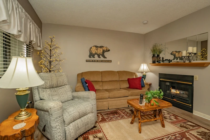 Unwind in your cozy mountain retreat with plush seating, a warm fireplace, and rustic charm that makes every moment feel like home.