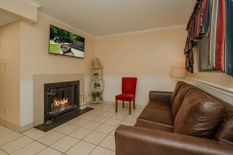 Unwind in your cozy living room where a crackling fireplace sets the perfect mood for relaxing evenings. Sink into comfortable seating and let the warmth embrace you after a day of mountain adventures.