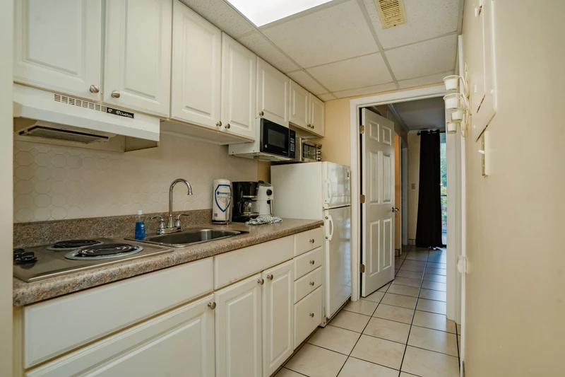 Your fully equipped kitchen features everything you need to prepare meals, from the stove and microwave to ample counter space and a coffee maker ready for your morning brew.