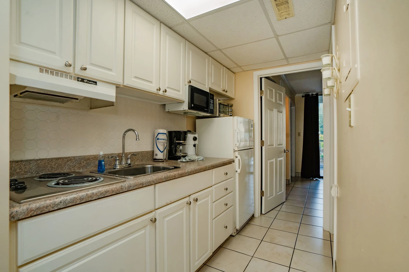 Your fully equipped kitchen features everything you need to prepare meals, from the stove and microwave to ample counter space and a coffee maker ready for your morning brew.