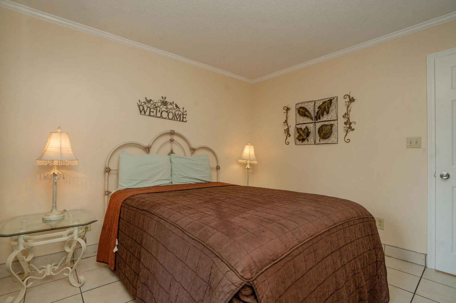 Slip into your peaceful retreat with a welcoming bedroom dressed in warm earth tones and soft bedside lighting that sets the mood for relaxation.