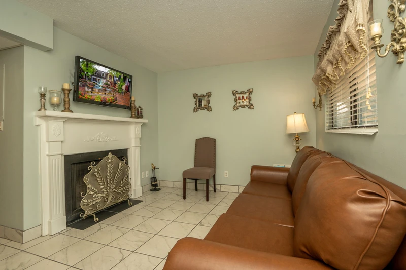 Settle into this inviting living space with a cozy fireplace and comfortable seating, where you can unwind after exploring the area.