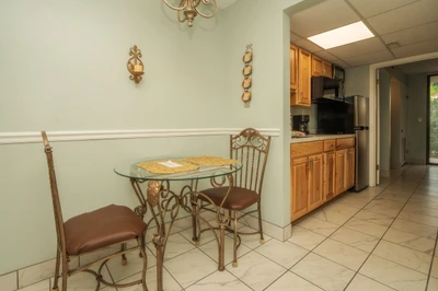 Sip your morning coffee at this cozy breakfast nook, then explore the fully equipped kitchen with warm wood cabinetry and modern appliances—everything you need to feel at home during your stay.