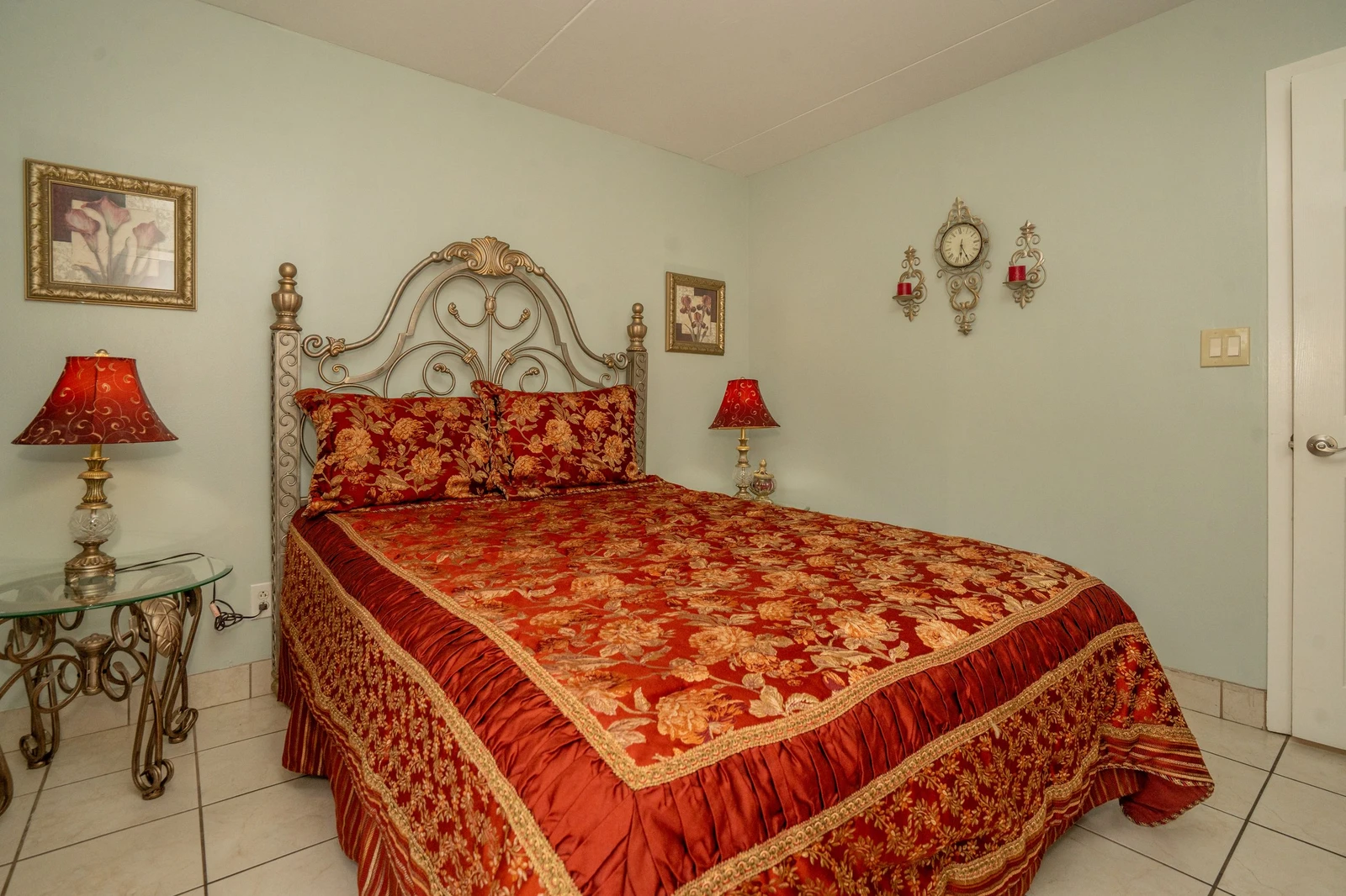 Sink into luxurious comfort in your elegantly appointed bedroom, where ornate details and rich fabrics create a warm, inviting retreat for restful nights.